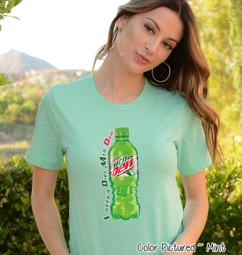 Mint green t-shirt featuring a graphic of a Diet Mountain Dew bottle. The text 