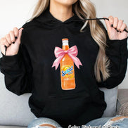 Black hooded sweatshirt featuring a graphic of a Sunkist Orange soda bottle with a pink bow. The bottle is orange with the Sunkist logo and the text 