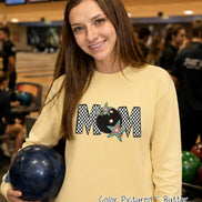 May include: A long-sleeve butter yellow shirt featuring a graphic print of the word MOM in a black and white checkered pattern. The letter O is replaced by a black bowling ball, and the design is accented with colorful star illustrations.
