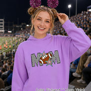 May include: A neon violet hooded sweatshirt featuring a graphic print of the word MOM in a black and white checkered pattern. The letter O is replaced by a brown football, and the design is accented with two colorful, multi-pointed stars.
