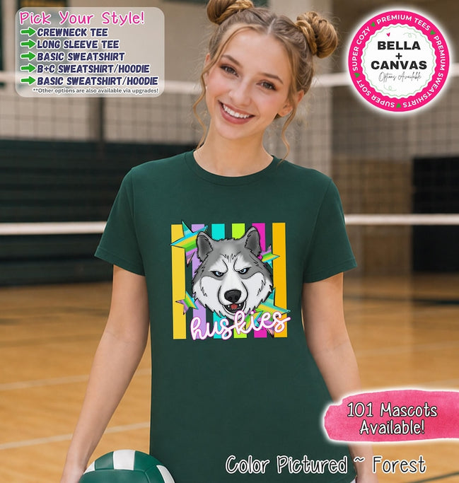 May include: A forest green short-sleeve crewneck t-shirt featuring a graphic of a grey and white husky dog head centered over vertical yellow and teal stripes and colorful stars. The word HUSKIES is printed in white script below the dog head.