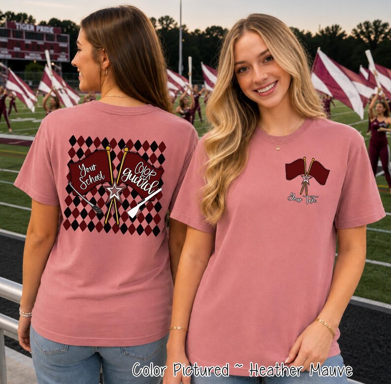 May include: A heather mauve t-shirt featuring a maroon and black diamond pattern on the back with two crossed flags and the text Your School and Color Guard. The front left chest displays two crossed flags with a star and the text Your Text.