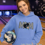 May include: A light blue hooded sweatshirt featuring a graphic print on the chest. The design displays the word MOM in a black and white checkered pattern, with a black bowling ball replacing the letter O and colorful star accents.