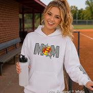 May include: A white hooded sweatshirt featuring a graphic print on the chest. The design displays the word MOM in a black and white checkered pattern, with a yellow softball replacing the letter O and colorful star accents surrounding it.