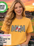May include: A citrus yellow short-sleeve t-shirt featuring a graphic design that spells MOM. The letters M are filled with a black and white checkerboard pattern, while the O is replaced by a red and white baseball with colorful star accents.