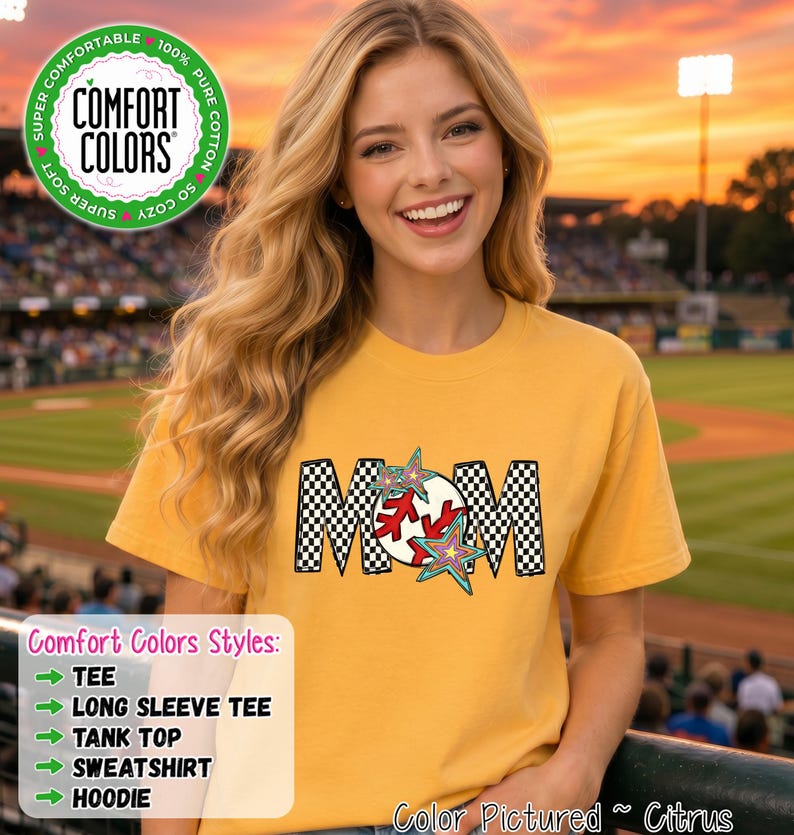 May include: A citrus yellow short-sleeve t-shirt featuring a graphic design that spells MOM. The letters M are filled with a black and white checkerboard pattern, while the O is replaced by a red and white baseball with colorful star accents.