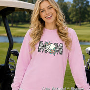 May include: A light pink long-sleeve sweatshirt featuring a graphic on the chest that spells MOM in a black and white checkered pattern. The letter O is replaced by a white golf ball, and two colorful star shapes are layered over the letters.