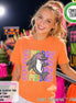 May include: An orange short-sleeve t-shirt featuring a graphic of a grey dolphin with a pink star over its eye. The text "GAME DAY" is repeated four times in colorful, outlined letters behind the dolphin. The shirt has a round neckline.