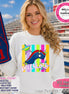 May include: A white crewneck sweatshirt featuring a graphic of a blue, red, and white tricorn hat, colorful vertical stripes, and stars. The word patriots is printed in white script below the hat. A blue foam finger with the number 1 is visible.