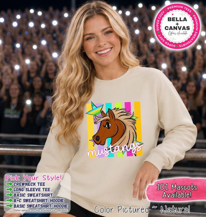 May include: A natural-colored crewneck sweatshirt featuring a graphic of a brown horse head with a flowing mane, positioned in front of vertical neon-colored stripes and a star. The word mustangs is printed in white script below the horse graphic.