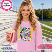 May include: A light pink crewneck sweatshirt featuring a graphic print of a feathered headdress in black, white, and purple, layered over colorful vertical stripes and stars, with the word indians written in white script lettering across the front.