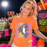 May include: A melon-colored short-sleeve t-shirt featuring a graphic of a gray dolphin with a pink star over its eye. The text 