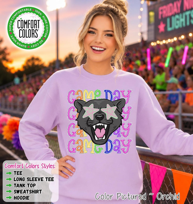 May include: A light purple crewneck sweatshirt featuring a graphic of a black panther head with star-shaped eyes. The text 
