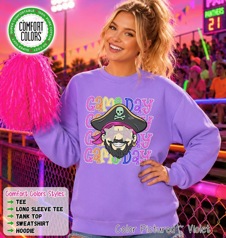 May include: A violet long-sleeve sweatshirt featuring a graphic of a pirate wearing star-shaped sunglasses. The text 