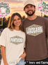 Two short-sleeve crew neck t-shirts. One is ivory with a central hexagonal graphic containing a camouflage pattern and the white text PANTHERS. The other is espresso brown with a matching hexagonal graphic and the white text JAGUARS.