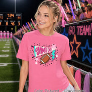A bright pink short-sleeved t-shirt featuring a graphic print with the text 'GAME DAY' in pink, a brown football, a teal megaphone, a teal lightning bolt, and various pink and white stars surrounded by small black dots.
