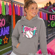 A grey hooded sweatshirt featuring a graphic print on the front. The design includes a white baseball with red stitching, a pink pennant flag with the text GAME DAY, a blue lightning bolt, and several small pink stars and black dots.