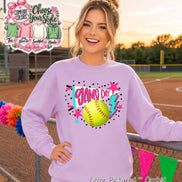 A light purple crewneck sweatshirt featuring a graphic print with a yellow softball, a teal and white pennant flag with the text 