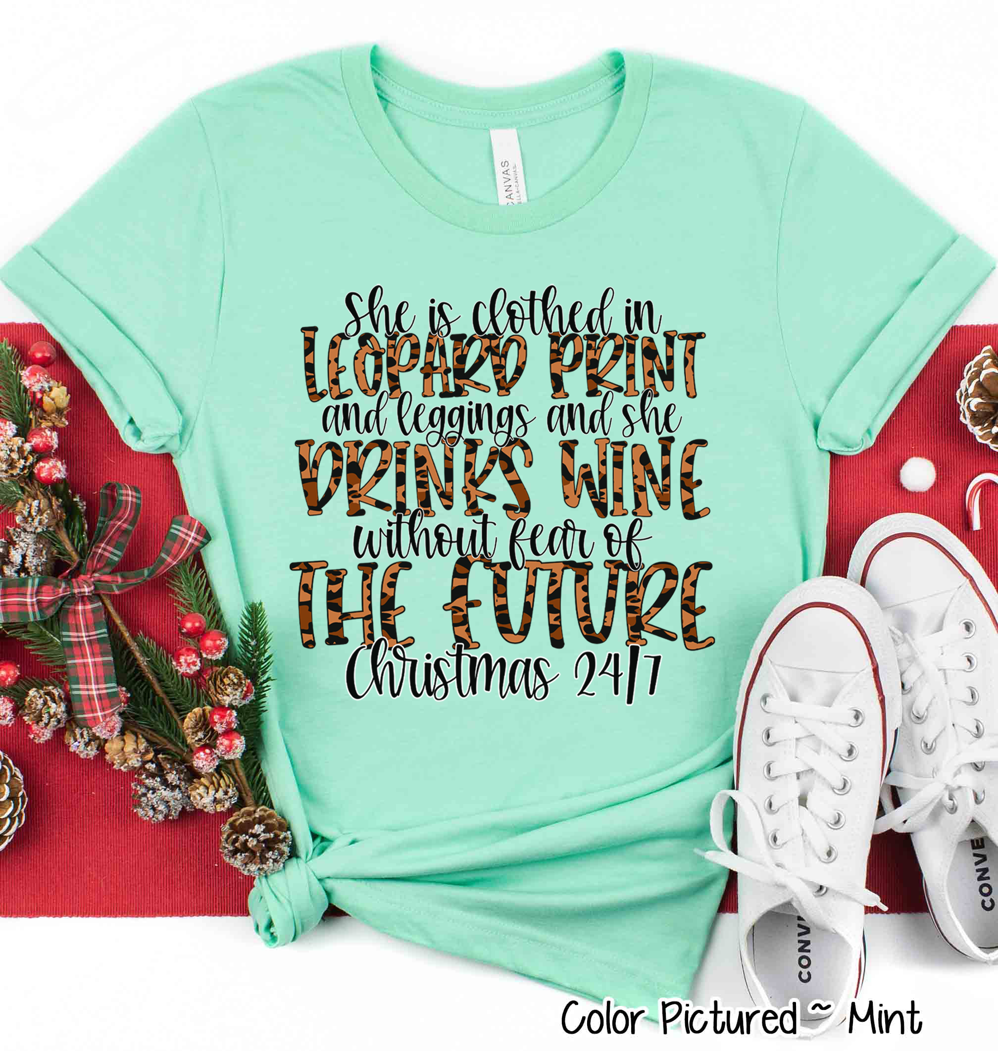 She is clothed in Leopard Print Christmas Movie Tee