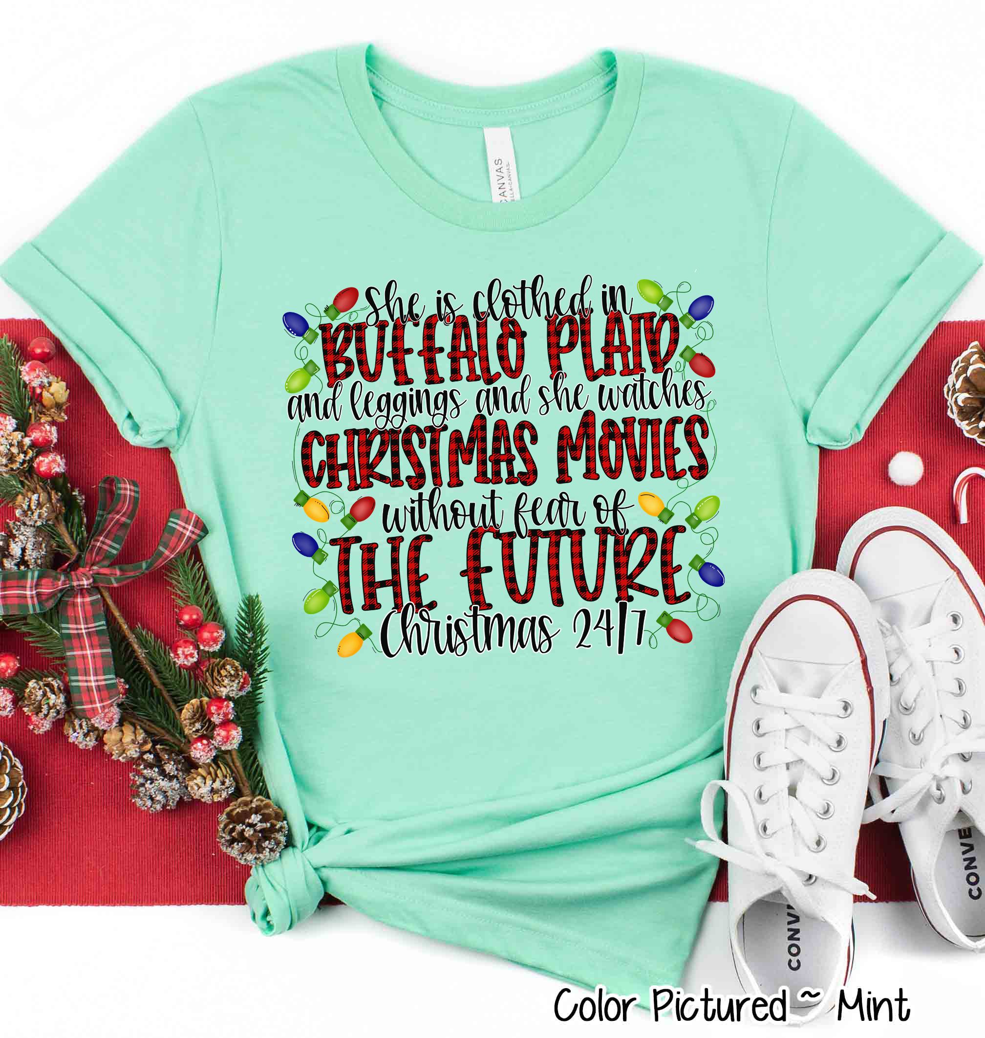She is clothed in Buffalo Plaid Christmas Movie Tee