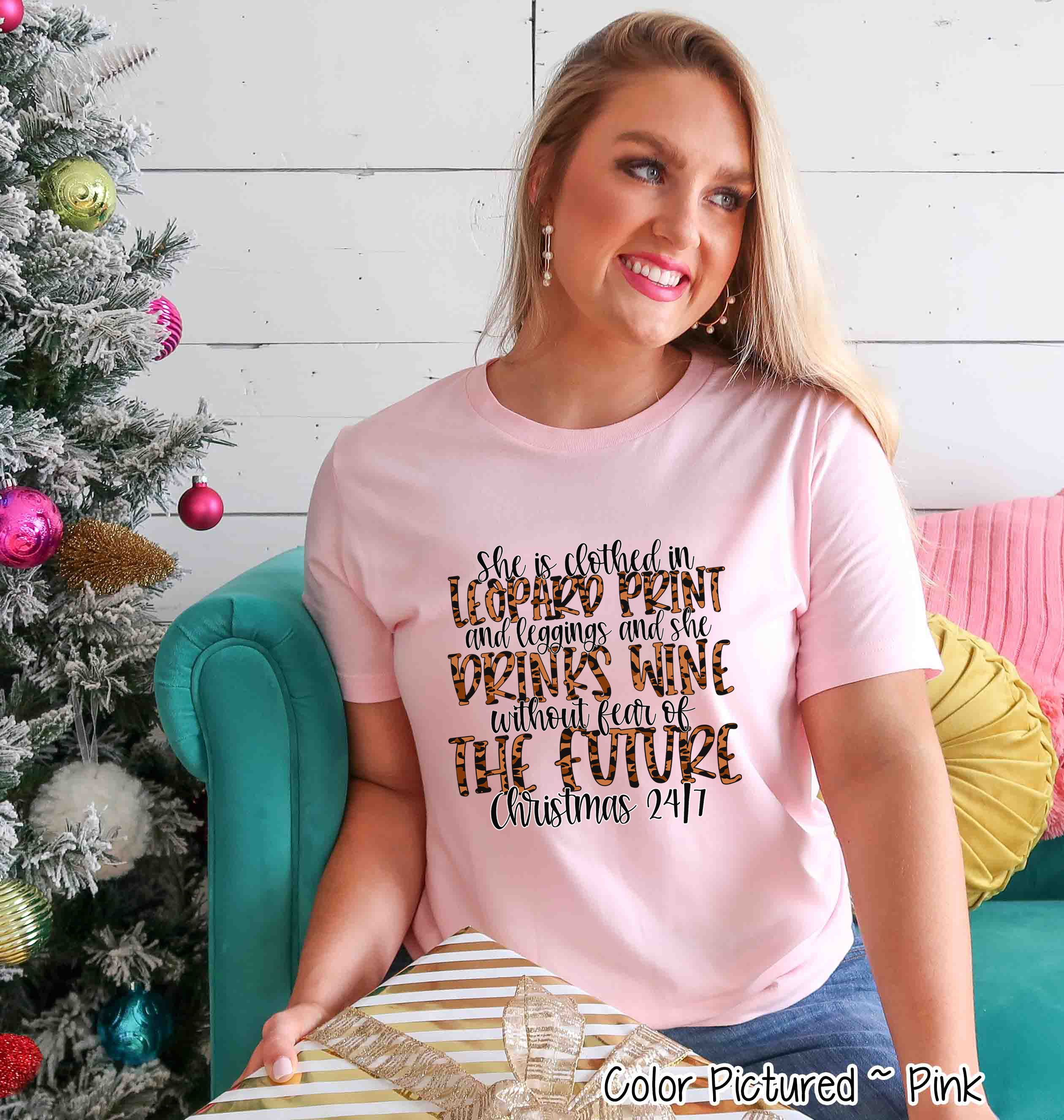 She is clothed in Leopard Print Christmas Movie Tee