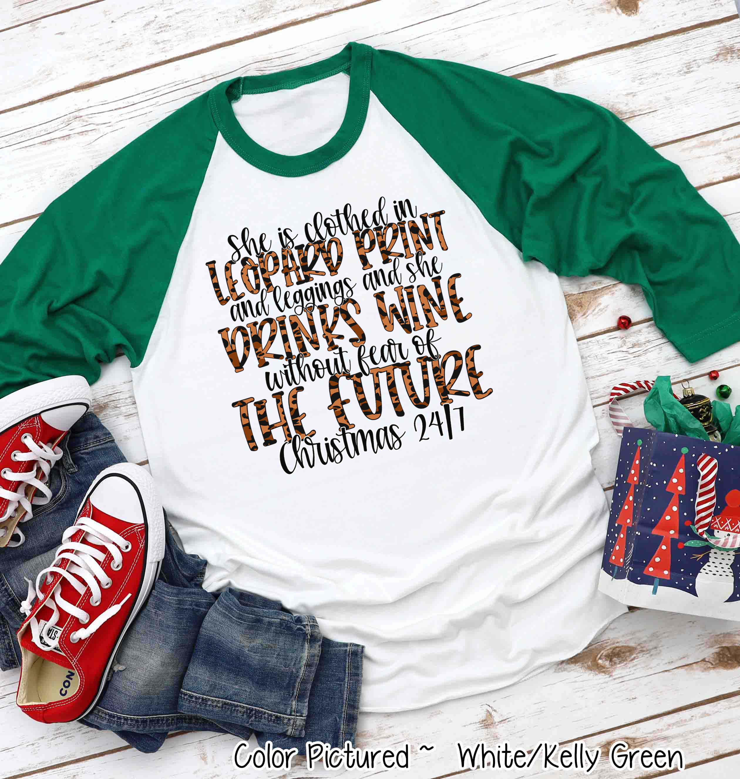 She is clothed in Leopard Print Christmas Movie Raglan Tee